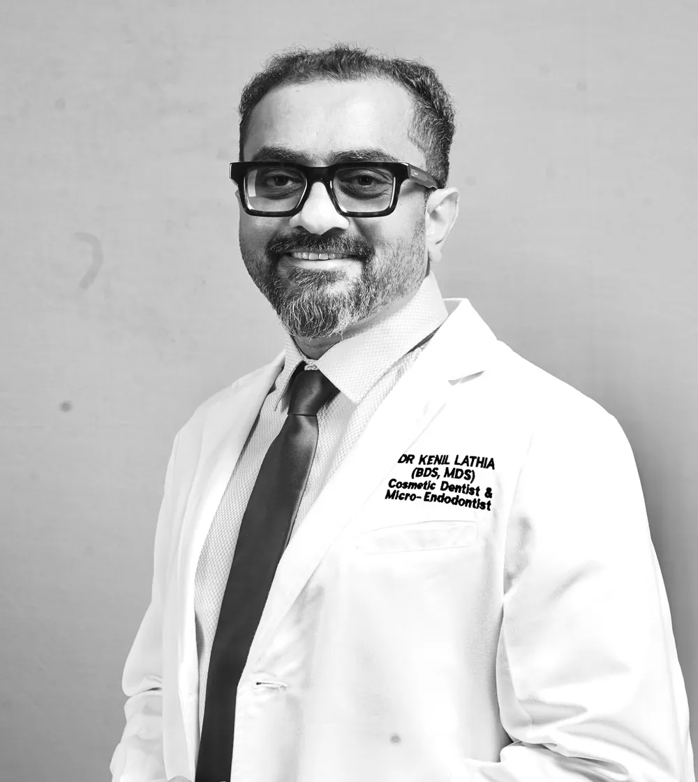 Dr. Kenil Lathia, BDS, MDS, cosmetic dentist and micro-endodontist, in a white coat